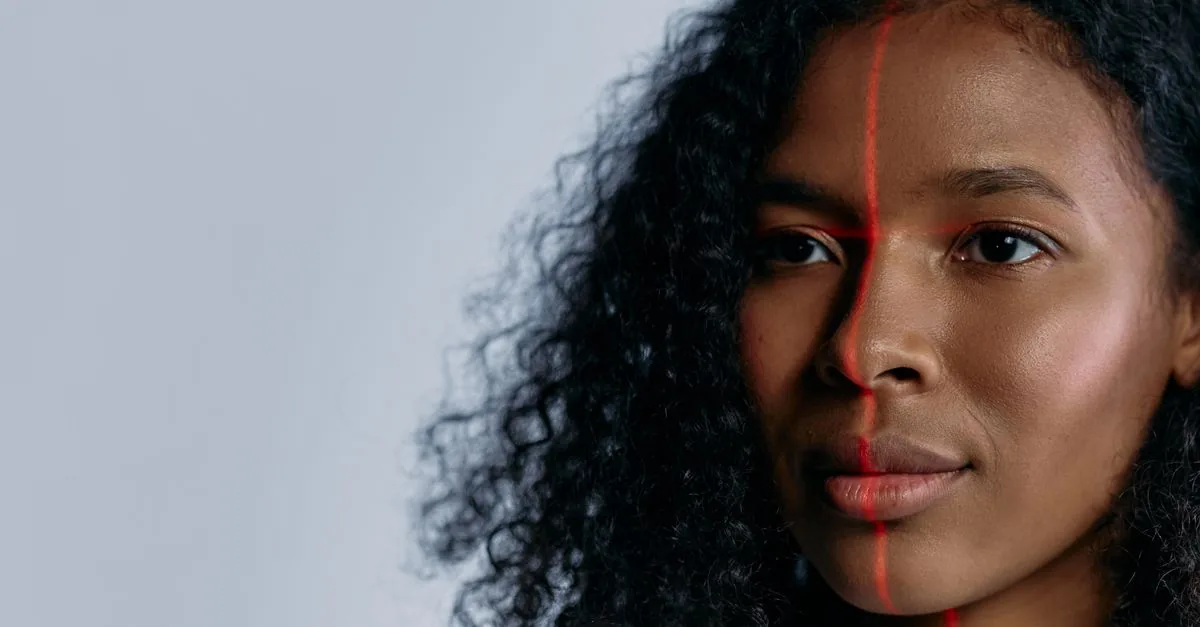 Close-up of a woman scanned with a laser for facial recognition, showcasing advanced technology.